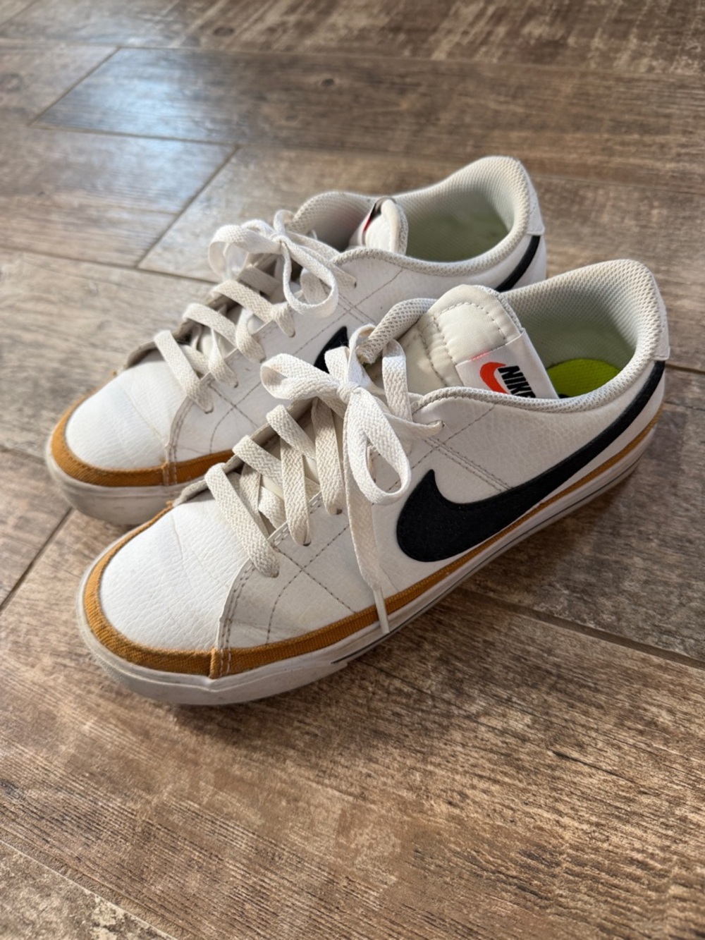 Nike White Sneakers with Black Swoosh and Gold Trim